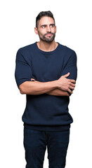 Fototapeta premium Young handsome man wearing sweater over isolated background smiling looking side and staring away thinking.
