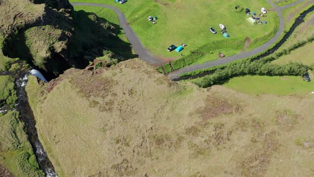 Drone Over Green Landscape Surrounding Gljufrabui Waterfall