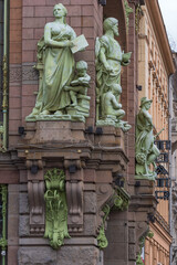 Fototapeta na wymiar Statues of Science, Industry and Commerce in the facade of Elisseeff Emporium in St. Petersburg, Russia