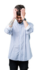 Young handsome man wearing glasses over isolated background suffering from headache desperate and stressed because pain and migraine. Hands on head.