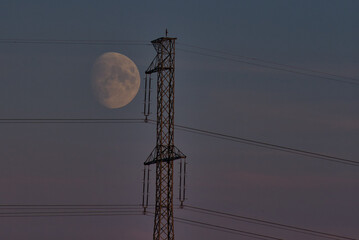 High Voltage Electricity Pole with big moon on the sky © A.R.