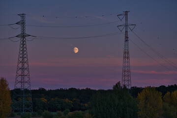 High Voltage Electricity Poles and moon in between © A.R.