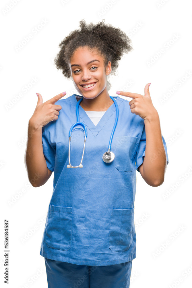 Sticker young afro american doctor woman over isolated background smiling confident showing and pointing wit