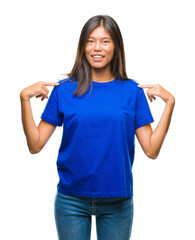 Young asian woman over isolated background looking confident with smile on face, pointing oneself with fingers proud and happy.