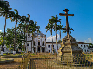 Centenary Portuguese colonial-style church next to palm trees and a cruise in the city of Goiana,...