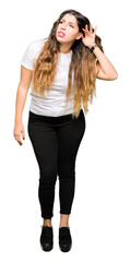 Young beautiful woman wearing casual white t-shirt smiling with hand over ear listening an hearing to rumor or gossip. Deafness concept.
