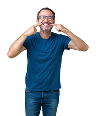 Handsome middle age hoary senior man wearin glasses over isolated background smiling confident showing and pointing with fingers teeth and mouth. Health concept.