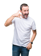 Middle age hoary senior man wearing white t-shirt over isolated background smiling doing phone gesture with hand and fingers like talking on the telephone. Communicating concepts.