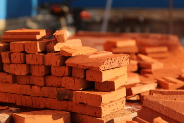 Tiny dark orange bricks on a table at sunset color