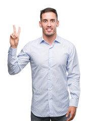 Naklejka premium Handsome young businessman showing and pointing up with fingers number two while smiling confident and happy.