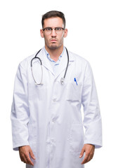 Handsome young doctor man skeptic and nervous, frowning upset because of problem. Negative person.