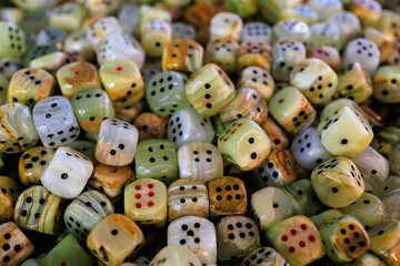 Dice made of natural stone. Background with selective focus and copy space