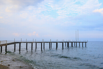 Obraz premium Old pier on the public central beach. Background with copy space