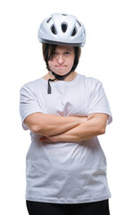 Young adult cyclist woman with down syndrome wearing safety helmet over isolated background skeptic and nervous, disapproving expression on face with crossed arms. Negative person.