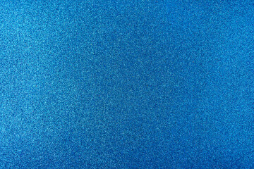 Background with sparkles. Backdrop with glitter. Shiny textured surface. Strong blue