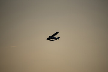silhouette of an airplane flying in the sky
