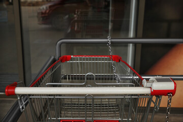 New empty metal shopping cart outdoors, closeup