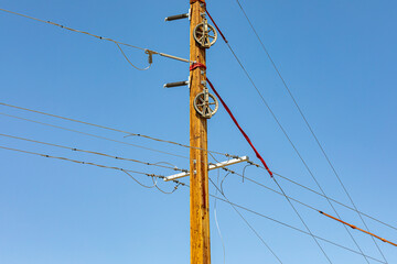 Laminated utility power pole ready for electric line installation. Infrastructure maintenance,...