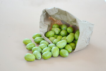 Paper Kraft Bag with Raw Green Olives Spilling Out