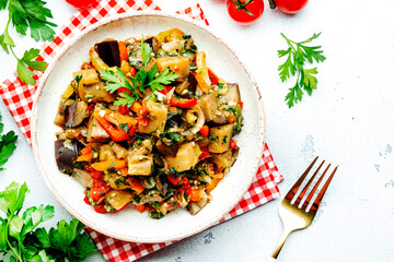 Vegetable stew, saute or caponata. Stewed eggplant with paprika, tomatoes, spices and herbs. White...
