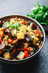 Vegetable stew, saute or caponata. Stewed eggplant with paprika, tomatoes, herbs and spices. Black...