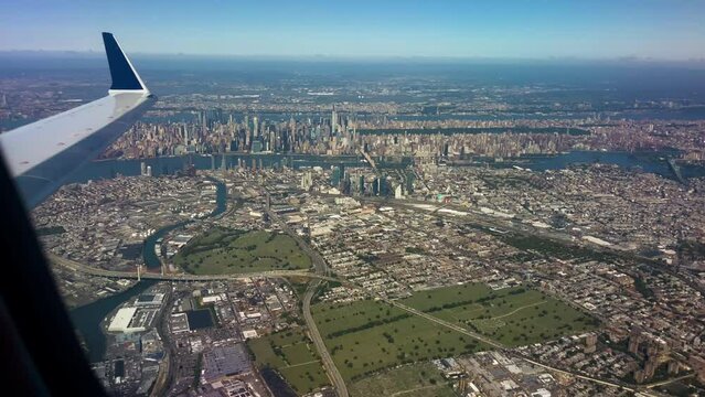New York City Viewed From Window Of Airplane With Wing In View
