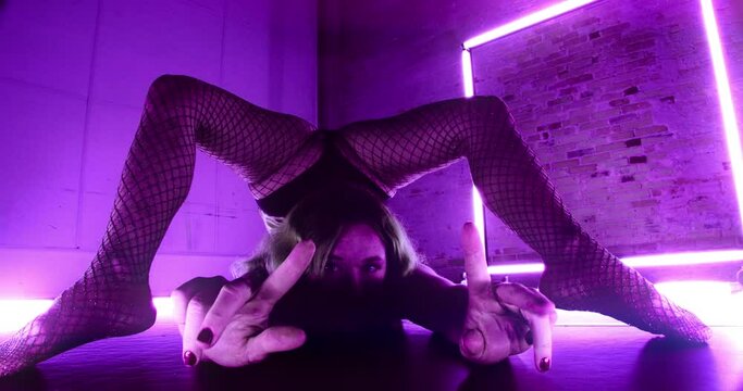 Contortionist With Feet Touching Floor In Front Of Her