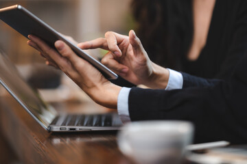 Happy laughing business woman using laptop computer for distant work. Hipster young Asian manager female working in the cafe connected to wireless internet connection, concept of freelance work