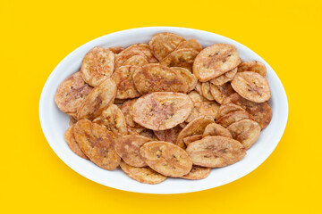 Banana chips on yellow background.