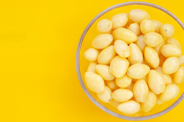 Boiled ginkgo nuts on yellow background.