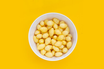 Boiled ginkgo nuts on yellow background.