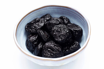 Dried prunes on white background