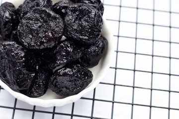 Dried prunes on white background
