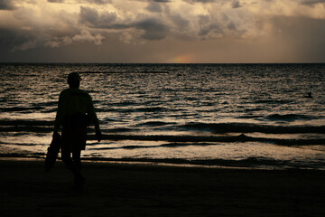 Fototapeta premium silhouette of lifeguard watching the sea and sunset