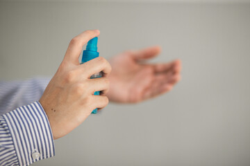 Man's hand holding Ethyl Alcohol spray. Spray on hand to kill germs for safety.
