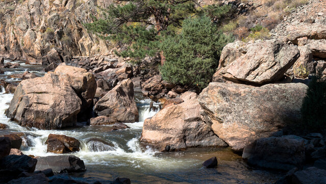 Boulders and whitewater rapids on the Cache La Poudre Wild and Scenic River in Colorado