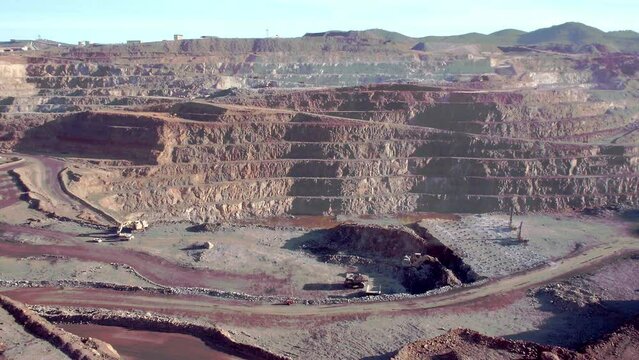 Static shot of Mars like copper open pit mining area where haul trucks are extraction ores owned by Rio Tinto group