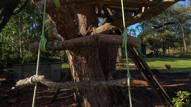 POV up rope ladder to basic DIY wooden pallet treehouse platform built for kids