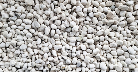 grunge white pebbles texture. small stones on the ground. top view of natural colorful gravel on japanese zen garden.