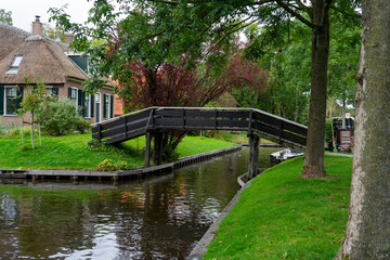 Fototapeta na wymiar Giethoorn Netherlands Venice of the North bridge over the canal in the village center