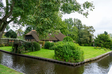 Fototapeta na wymiar Giethoorn Netherlands Venice of the North old house along the canals in the village center
