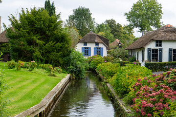 Fototapeta na wymiar Giethoorn Netherlands Venice of the North beautiful old white house in the village center