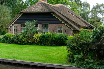 Fototapeta na wymiar Giethoorn Netherlands Venice of the North old house along the canal
