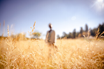 woman blurred in a golden autumn field © Rachel