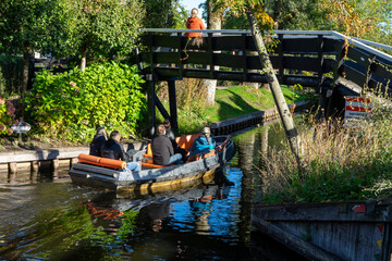 Giethoorn Netherlands Venice of the North people on a boat in the village center on the canals with...