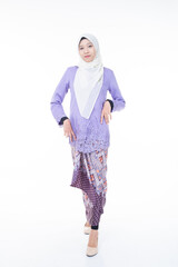 Portrait of a beautiful female model wearing hijab, a lifestyle apparel for Muslim women isolated on brown background. Idul Fitri and hijab fashion concept. Isolated on white background