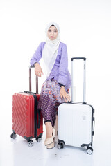 A traveling Asian Muslim woman wearing hijab with luggage bag for a trip. Isolated on white background