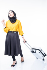 A traveling Asian Muslim woman wearing hijab with luggage bag for a trip. Isolated on white background