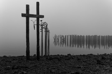 A bike hangs from the wooden remains of an old lumber mill in Tacoma, Washington on a foggy October...