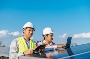 Two engineers are discussing during working at solar farm